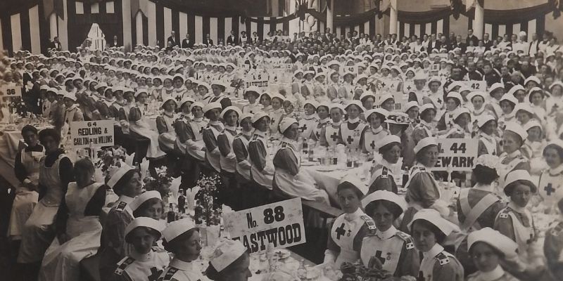 black and white archive photo of a crowd of nurses sat at dining tables