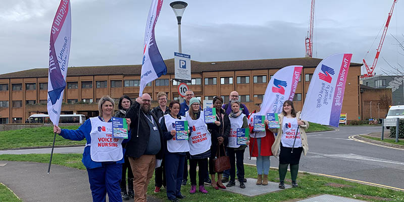 RCN members from Somerset NHS Foundation Trust hand their chief executive a collective car parking protest letter on 27 February (group with RCN flags and tabards)