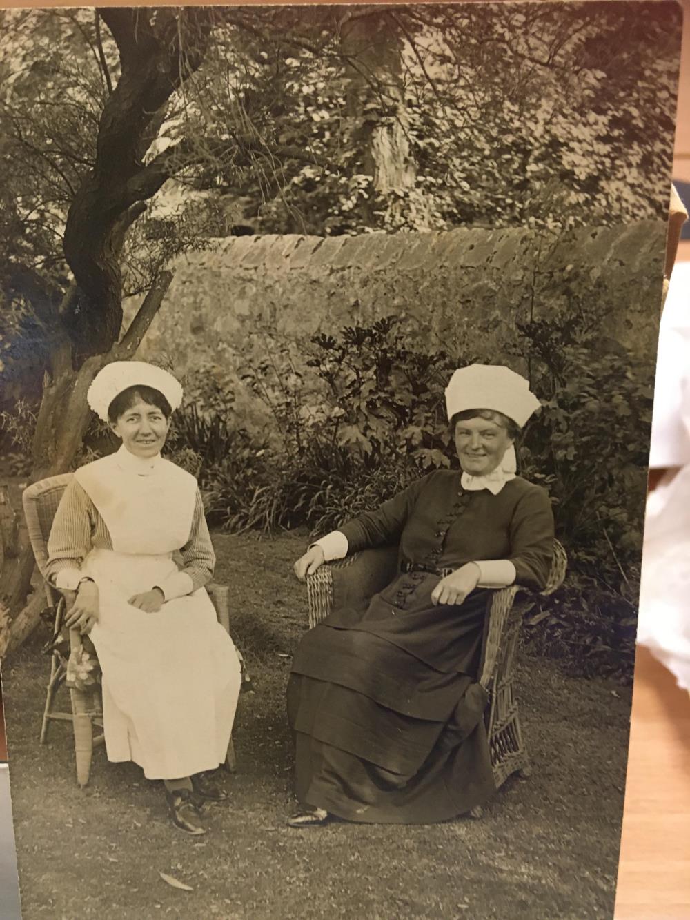 A happy looking sister and nurse sitting on wicker chairs in the garden of Morfa Hall, Rhyl 1921. The once private house became Rhyl Women's Convalescent Home in 1900.