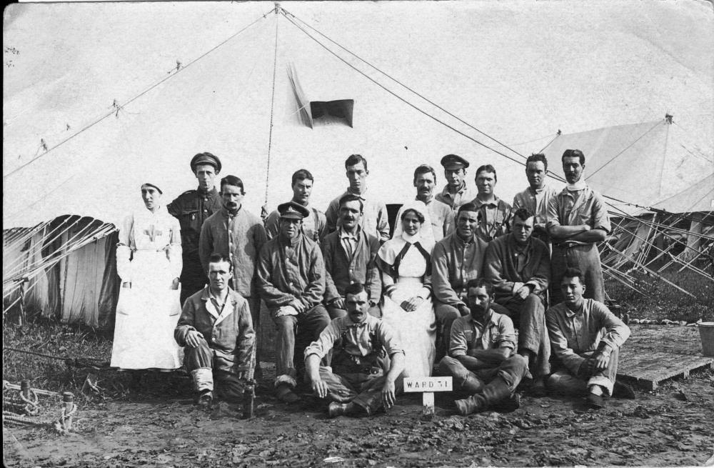 Black and white photograph of nursing staff posing with soldier patients